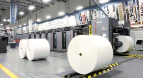 A impressora web de 121 toneladas usa rolos de papel de 16 quilómetros de comprimento e pode imprimir 55 000 páginas por hora, em mais de uma dúzia de línguas.